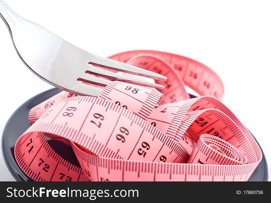 Measuring tape and fork isolated on white background