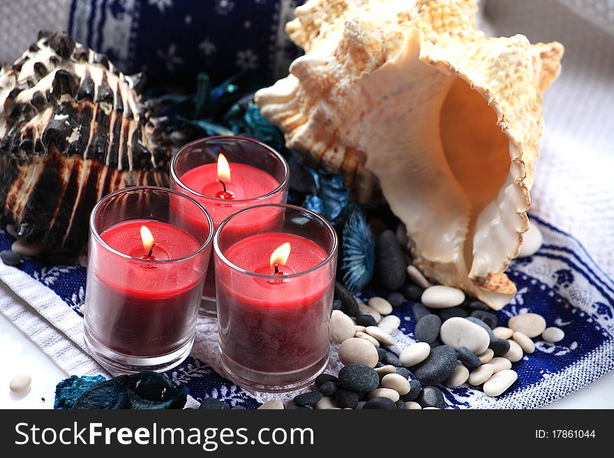 Candles and seashells placed on a towel. Candles and seashells placed on a towel