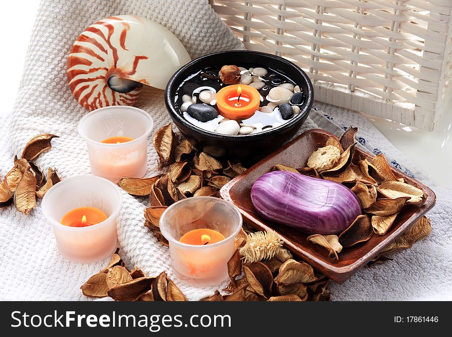 Seashell, candles and potpourri placed on a towel. Seashell, candles and potpourri placed on a towel