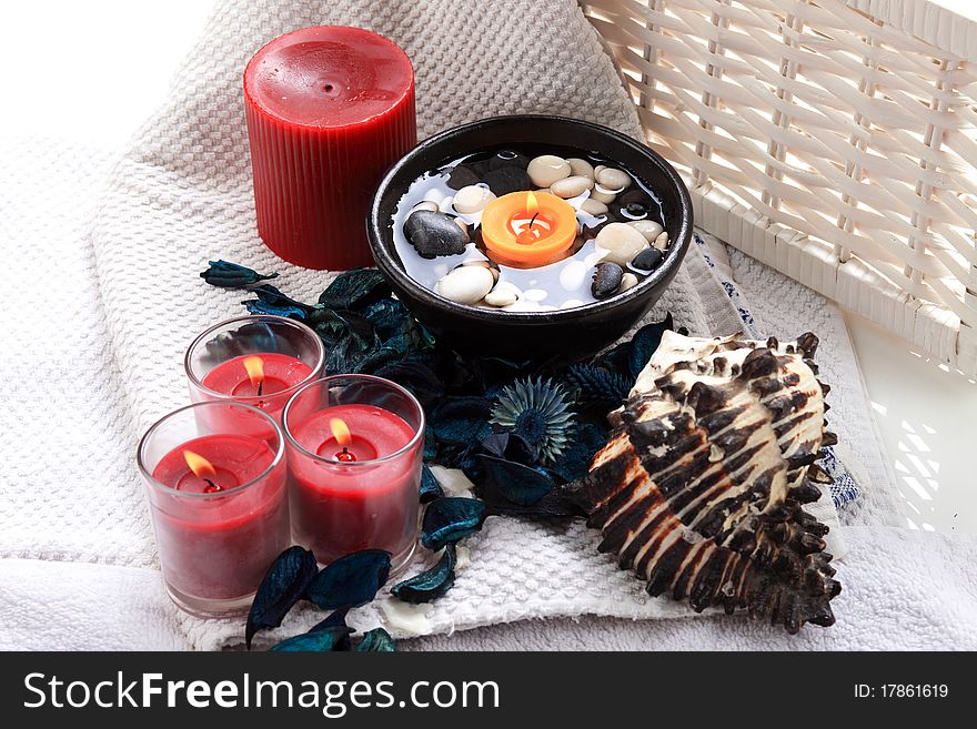 Seashell, candles and potpourri placed on a towel. Seashell, candles and potpourri placed on a towel