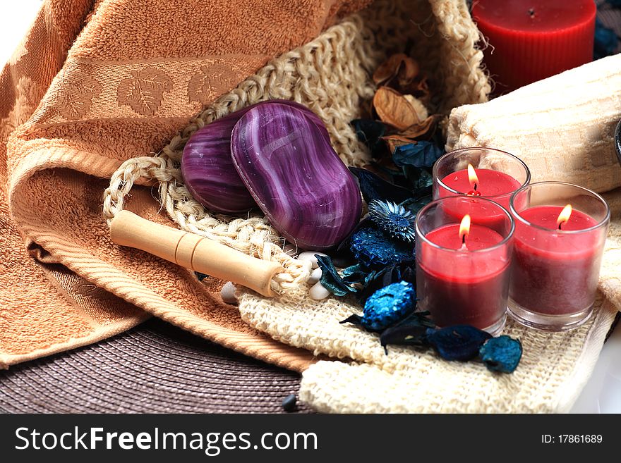 Three red candles and two soaps on a towels. Three red candles and two soaps on a towels