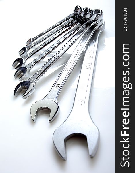 Set of steinless steel wrenches on a white background