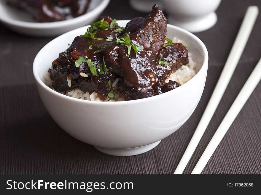 Marinated pork ribs in a sticky hoisin sauce with rice. Marinated pork ribs in a sticky hoisin sauce with rice