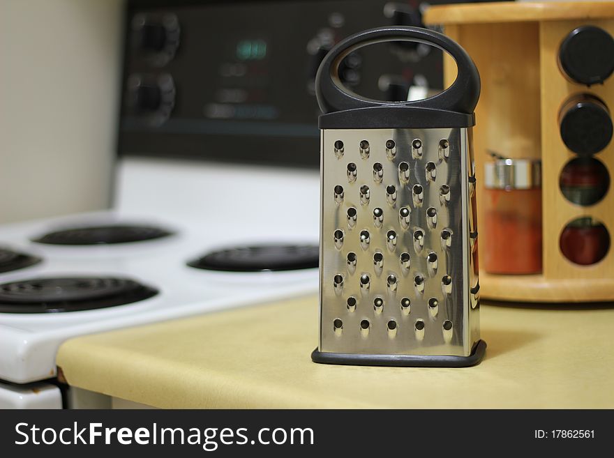 A cheese grater in a kitchen