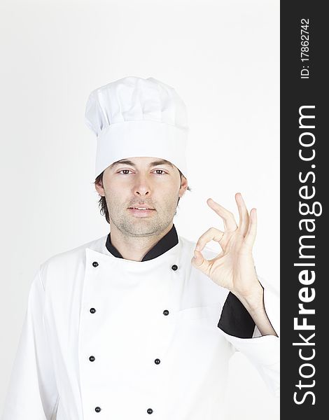 Professional male chef making a sign