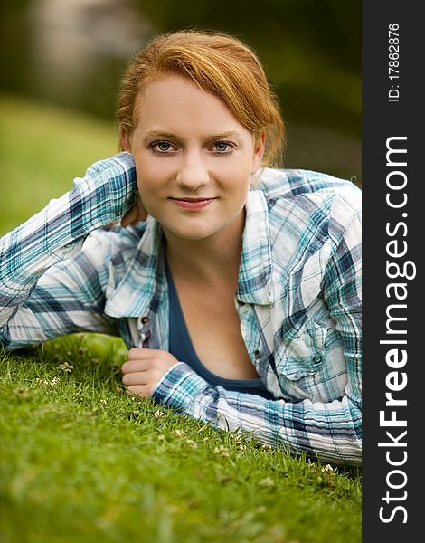 Pretty young woman sitting outside