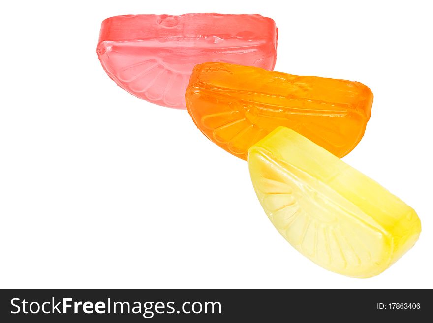 Fruit drop lemon, orange and grapefruit sections isolated on white