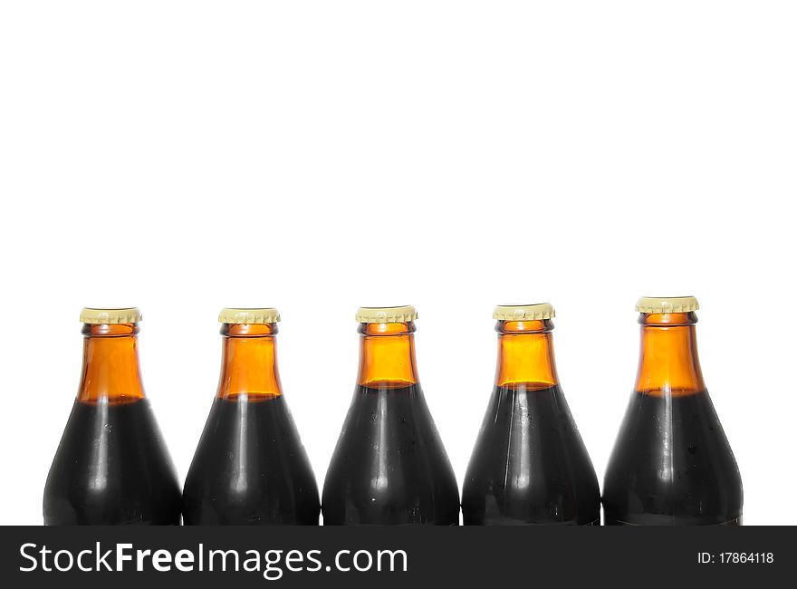 Five beer bottles isolated on a pure white background with blank copyspace above with room for your text.