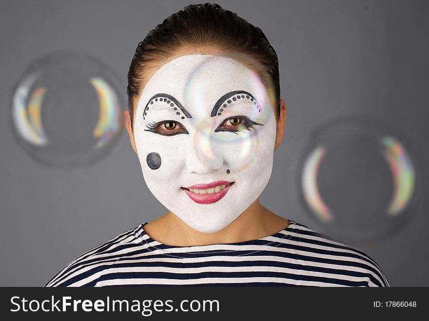 Asian mime looking to the camera trough the bubbles. Asian mime looking to the camera trough the bubbles