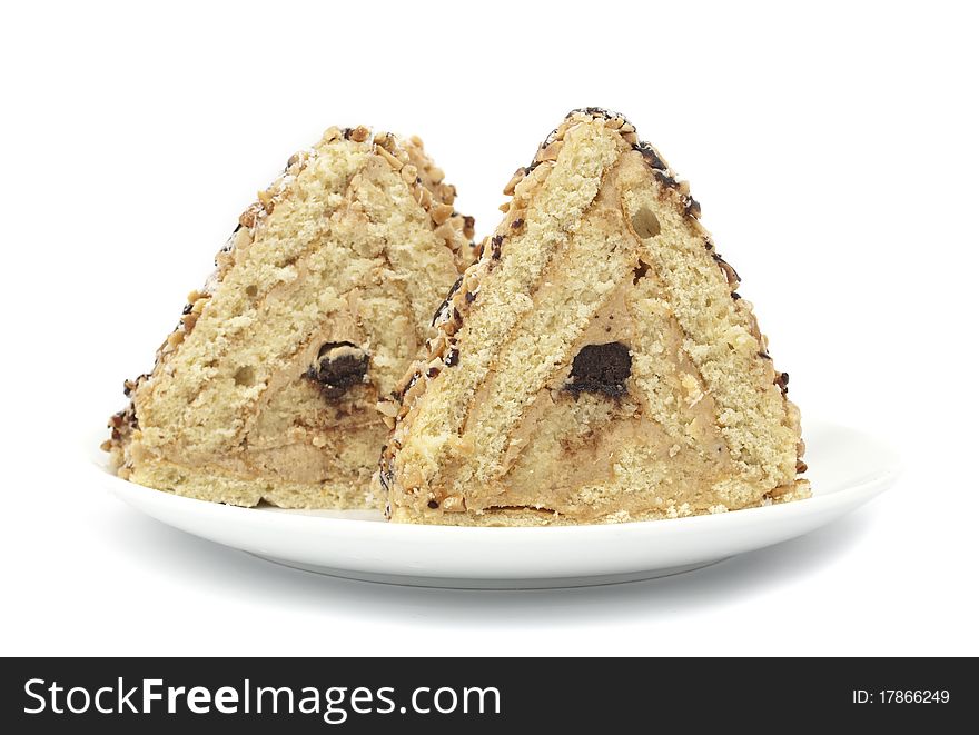 Piece of cake with nuts on white background