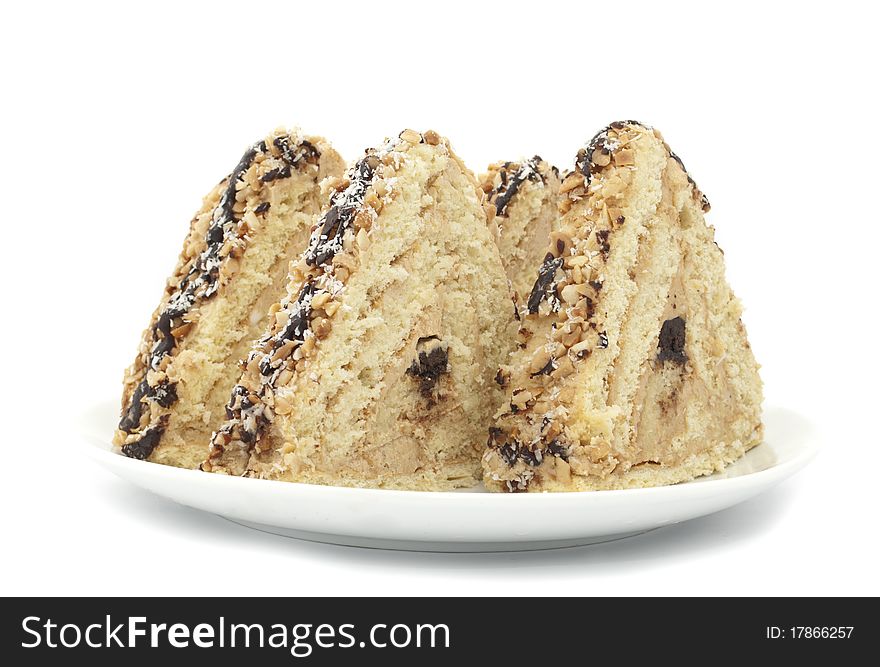 Piece of cake with nuts on white background