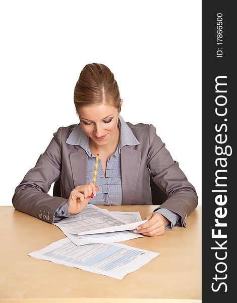 Woman in suit sitting at the desk isolated on white