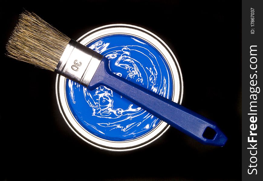 Blue Paint can and brush from above on black background. Blue Paint can and brush from above on black background