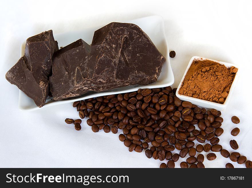 Pieces of chocolate with cocoa and coffee beans