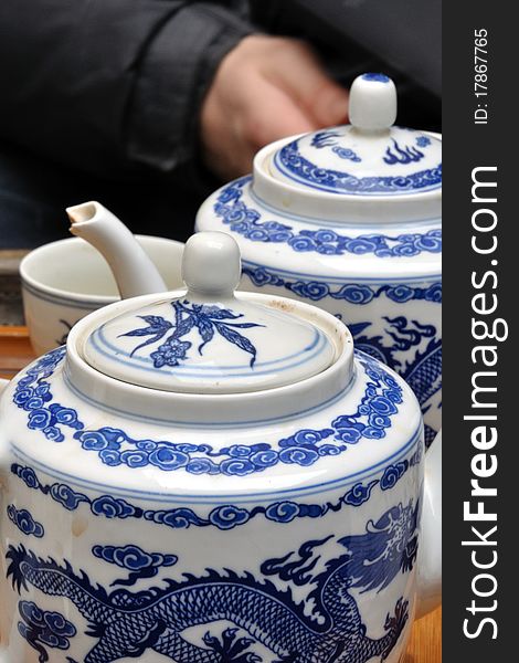 Close detail of chinese porcelain teapots with beautiful blue decoration - a dragon in the sky. Close detail of chinese porcelain teapots with beautiful blue decoration - a dragon in the sky