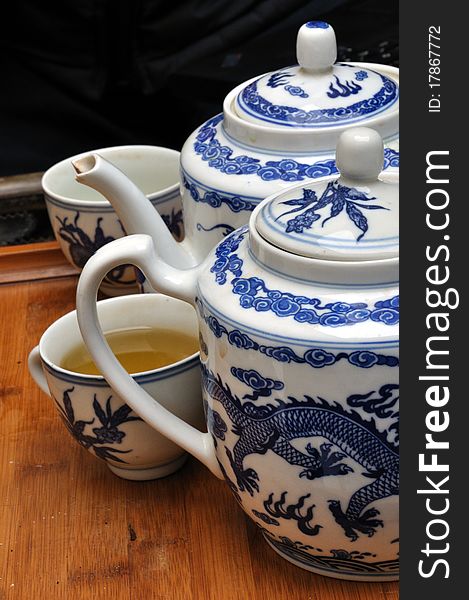 Close detail of chinese porcelain teapots with cup full of touareg tea. Close detail of chinese porcelain teapots with cup full of touareg tea