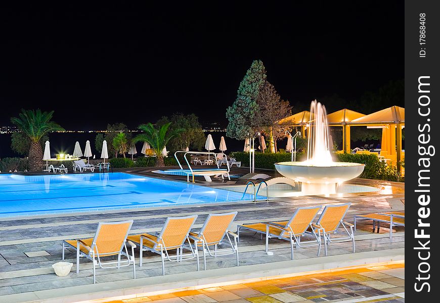 Water pool and fountain at night - vacation background