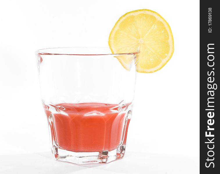 Red cocktail in whiskey glass over white background. Red cocktail in whiskey glass over white background.