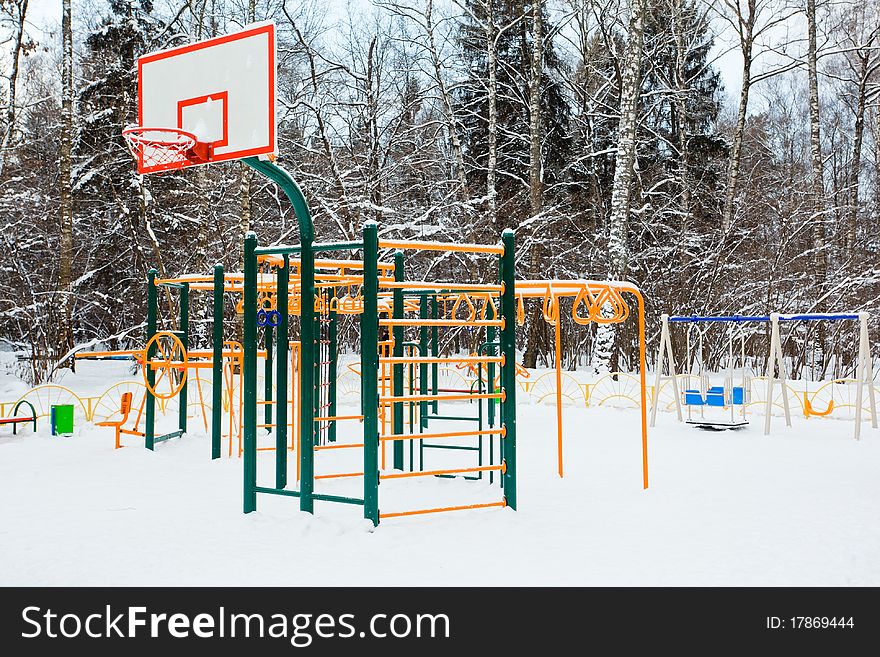 Playground under snow in winter forest. Playground under snow in winter forest