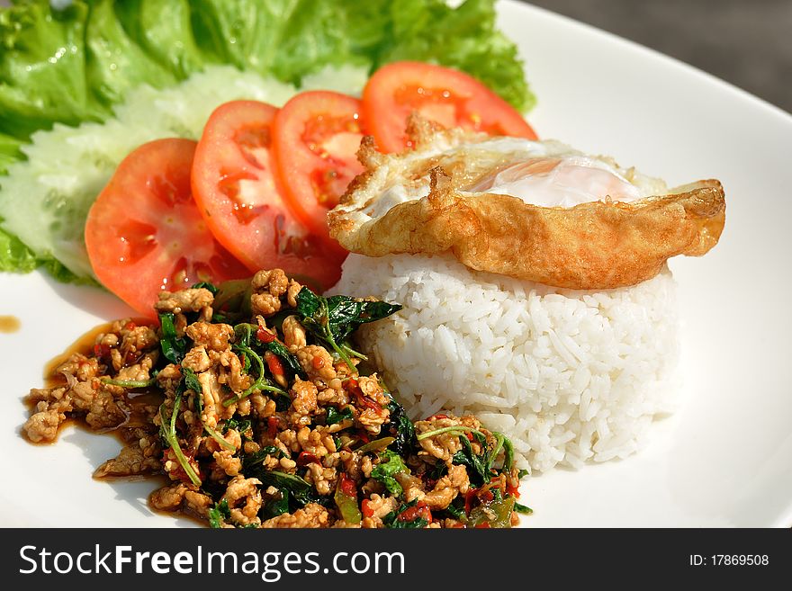 Thai spicy food, stir fried chicken whit basil on rice.