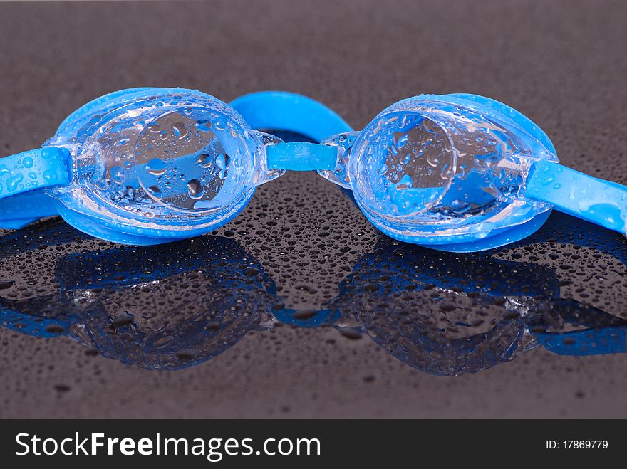 Image showing pair of wet swimming goggles and water droplets. Image showing pair of wet swimming goggles and water droplets