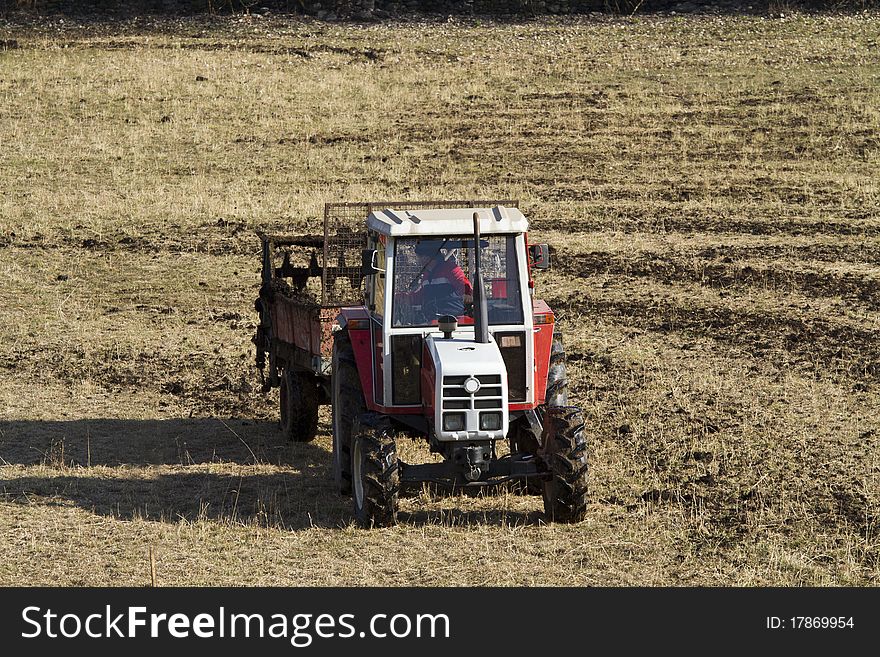 Work with the tractor in the grass. Work with the tractor in the grass