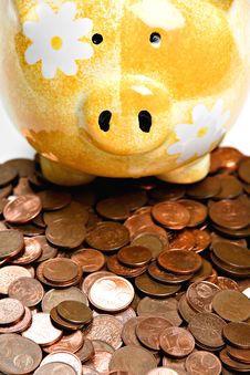Yellow Ceramic Piggy Bank On A Pile Of Cents Stock Photo