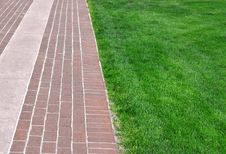 Brick Pathway Along Green Grass Stock Photography