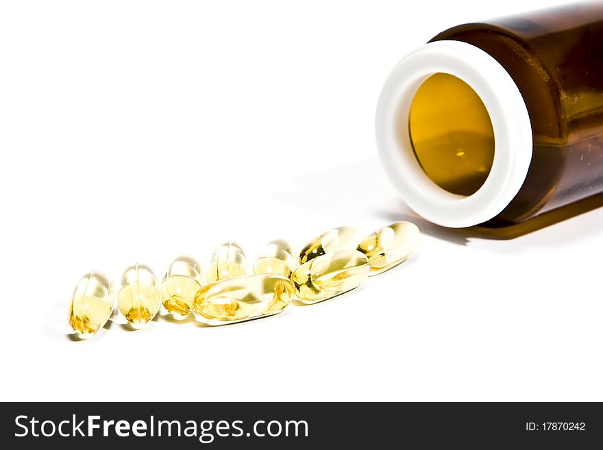 Vitamin pills with a bottle, on a white background