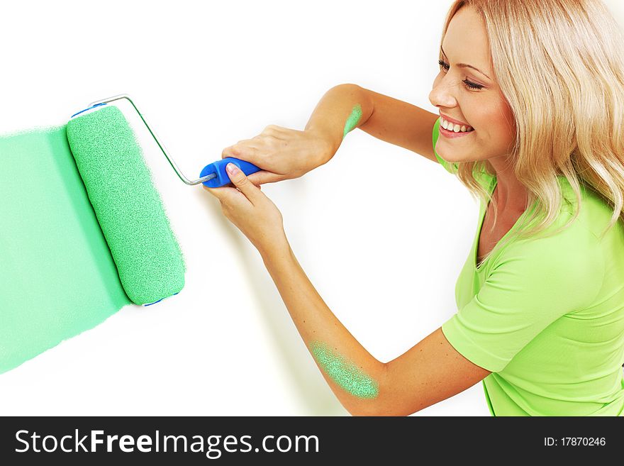 Woman paints the wall brush. Woman paints the wall brush