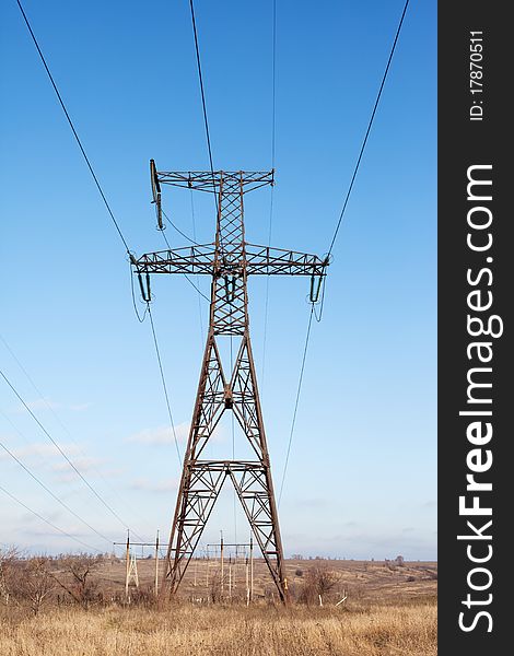 Transmission power line on blue sky background