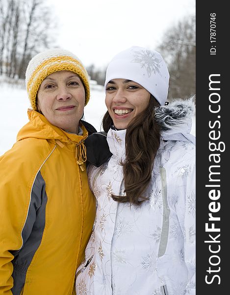 Two Happy Smiling Women In Winter Jackets And Caps