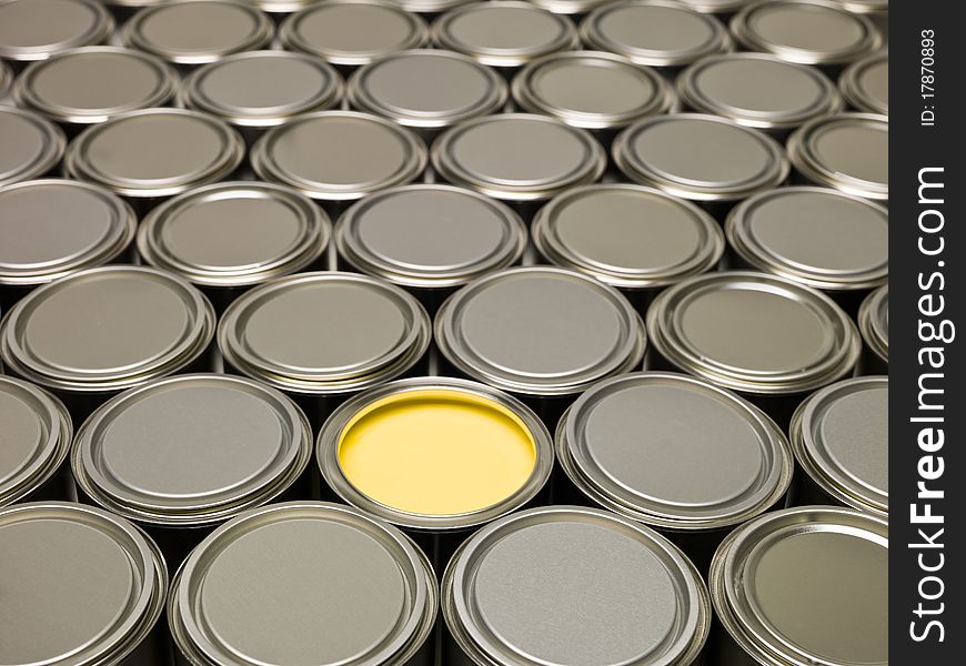 Full Frame of Paint Cans, one filled with Yellow paint