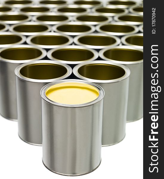 Yellow Paint can in front of a large group of Empty Paint Cans. Yellow Paint can in front of a large group of Empty Paint Cans