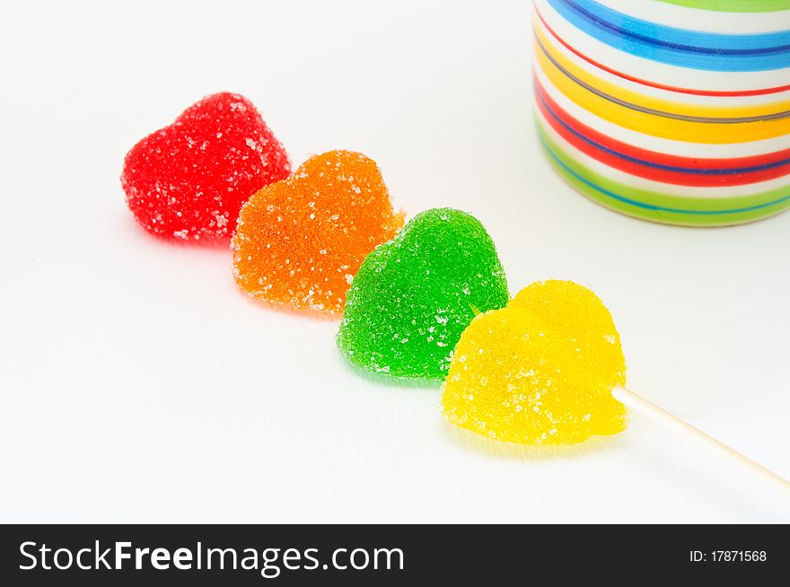 Four different color jelly beans over white background