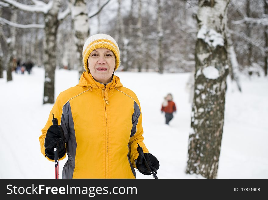 The Happy Woman In A Bright Yellow Cap And A Jacke
