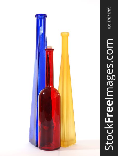 Colored glass vases on a white background