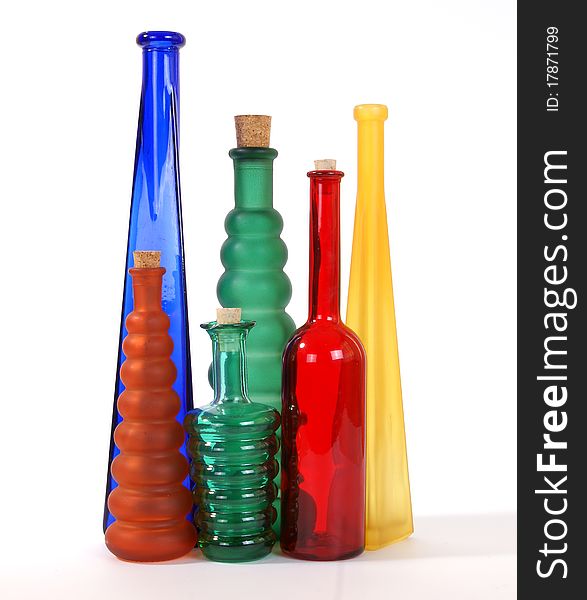 Colored glass vases on a white background