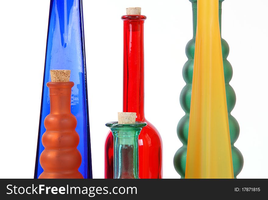 Colored glass vases on a white background