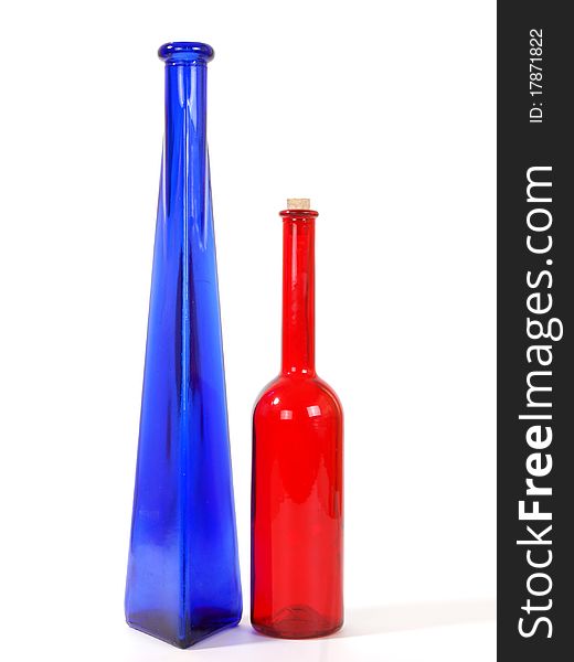 Colored glass vases on a white background