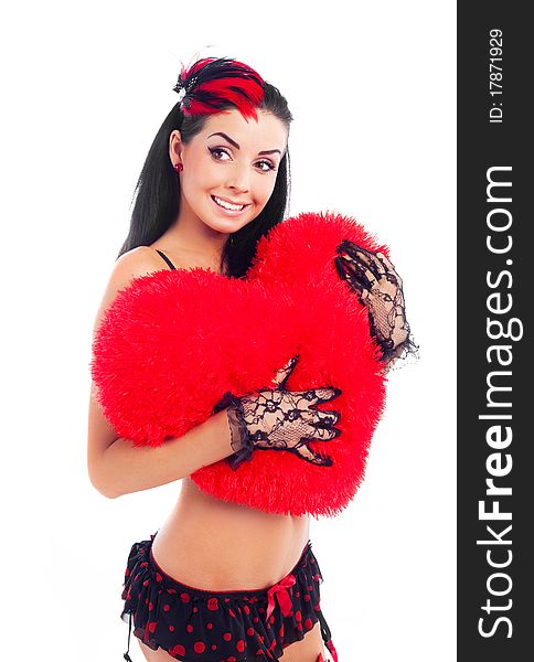young brunette woman wearing beautiful underwear with a heart shaped pillow in her hands. young brunette woman wearing beautiful underwear with a heart shaped pillow in her hands