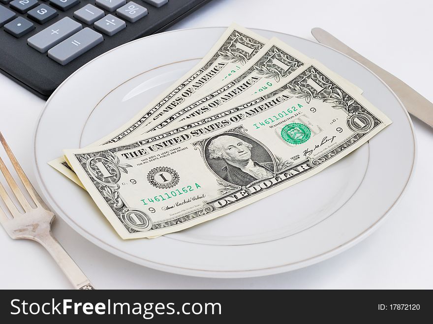 Dinner service with dollar denominations on plate and calculator buttons on backgrounds. Dinner service with dollar denominations on plate and calculator buttons on backgrounds