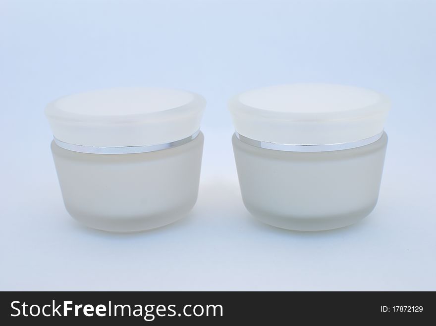 Two containers of cosmetic face cream close-up. Two containers of cosmetic face cream close-up