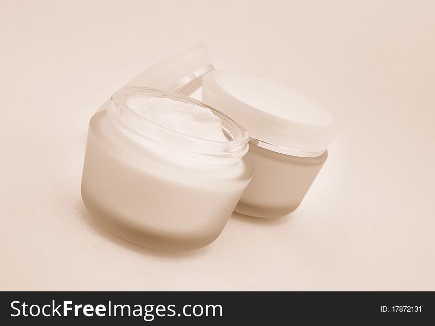 Containers of cosmetic face cream close-up. Sepia. Containers of cosmetic face cream close-up. Sepia