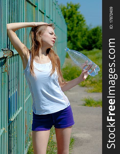 Beautiful girl on a tennis court on a background dark blue sky. Beautiful girl on a tennis court on a background dark blue sky