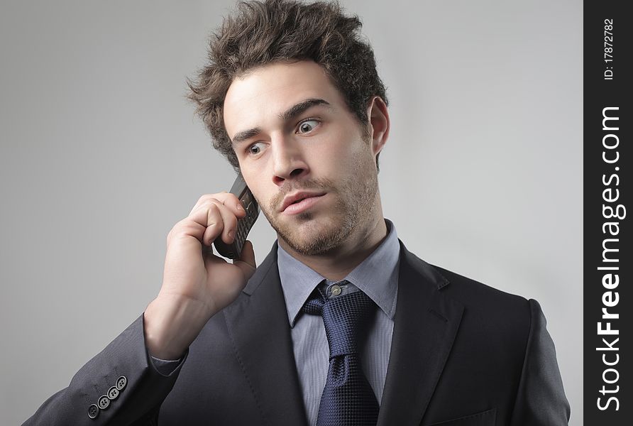 Businessman with worried expression using a mobile phone. Businessman with worried expression using a mobile phone