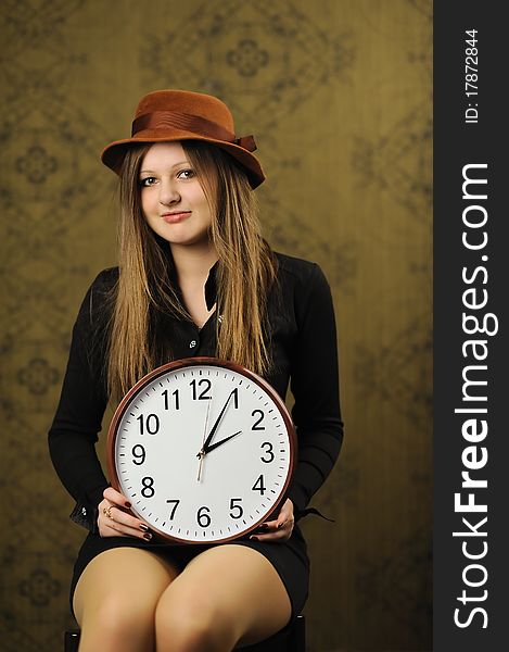 An image of a nice woman with a clock. An image of a nice woman with a clock