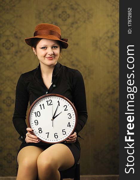 An image of a nice woman with a clock. An image of a nice woman with a clock