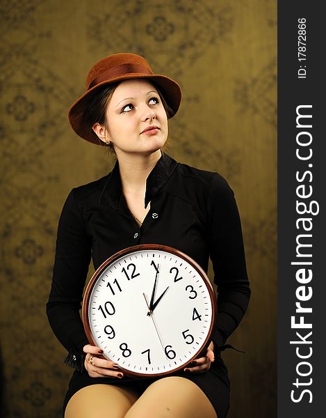 An image of a nice woman with a clock. An image of a nice woman with a clock