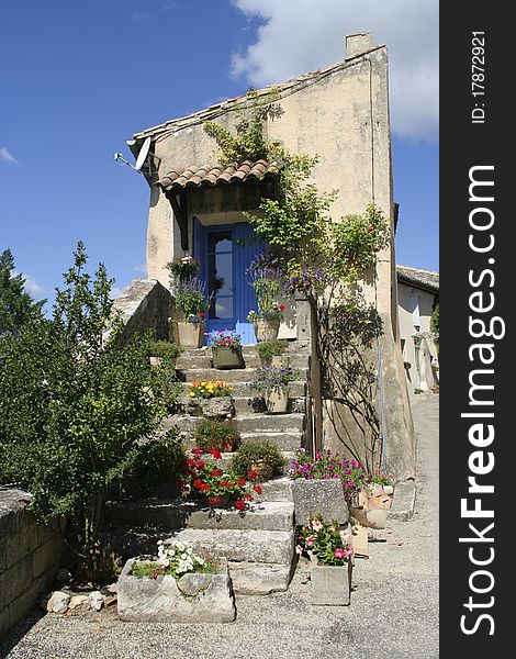Old entrance and stairs with blue door, Provence, France